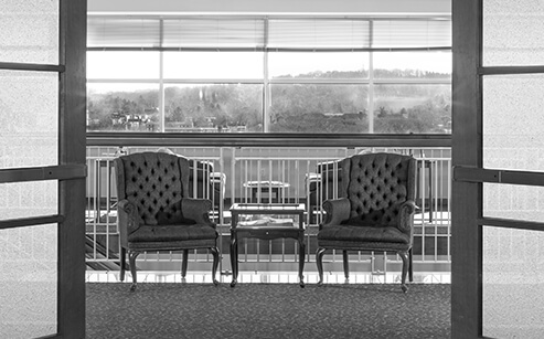 two armchairs located in the lobby of the stock and leader office